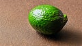 Green avocado close-up on a brown surface. Still life with avocado. Generated AI. Royalty Free Stock Photo