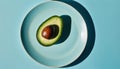 A green avocado on a white plate