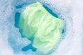 Green baby shorts soak in baby laundry detergent water dissolution, washing cloth, Laundry concept