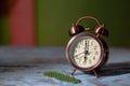 Green background with antique gold alarm clock Royalty Free Stock Photo