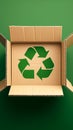 Green background with cardboard box featuring recycle symbol, eco concept Royalty Free Stock Photo