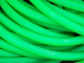 Green background created by a green garden plastic hose Royalty Free Stock Photo
