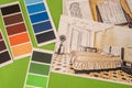 on a green background laid out colored palettes, samples and drawings of the house with a pencil Royalty Free Stock Photo