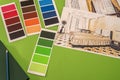 on a green background laid out colored palettes, samples and drawings of the house with a pencil Royalty Free Stock Photo