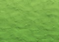 Green background with texture of soft clay or modeling dough. Background for screensavers and background for new illustrations Royalty Free Stock Photo