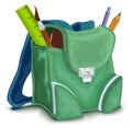 Green backpack with school supplies Royalty Free Stock Photo