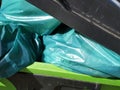 Green bags of rubbish in a bin
