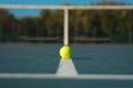Green ball on white line at empty court during sunny day Royalty Free Stock Photo