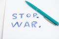 Green ballpoint pen and inscription stop war white sheet Royalty Free Stock Photo