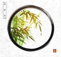 Green bamboo in black enso zen circle on rice paper background. Hieroglyphs - peace, tranquility, clarity, eternity