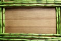 Green bamboo stems and space for text on wooden background Royalty Free Stock Photo