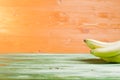 Green bananas on a green chalkboard on the background of yellow