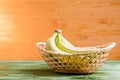 Green bananas on a green chalkboard on the background of yellow