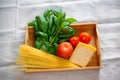 Green basil, chunk of parmesan cheese, raw cappellini and tomatoes