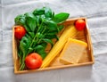 Green basil, chunk of parmesan cheese, raw cappellini and tomatoes Royalty Free Stock Photo