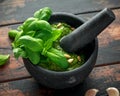 Green Basil Pesto in marble mortar with pine nuts and garlic Royalty Free Stock Photo