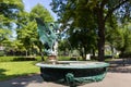 Green Basilisk Fountain spouting water in basin at Stadtpark, City Park in Vienna, Austria