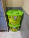 green basket in the corner of the wall next to the locker cupboard