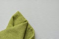 Green bath towel on a white textured background Royalty Free Stock Photo