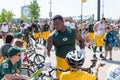 Green Bay Packer Player Riding Bike with Young Fan