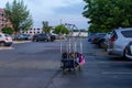 Unattended hotel luggage cart with bags, sits in the parking lot Royalty Free Stock Photo
