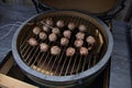 Green BBQ egg grilling meatballs with bacon Royalty Free Stock Photo