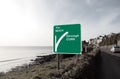Green beach road sign