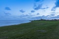 Green beach, sea, breakwater and blue sky