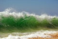 A green beachbreak wave over sky Royalty Free Stock Photo