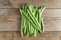 Green bean on wood background.