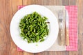 Green Beans Fried with Garlic on a White Plate