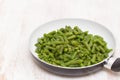 Green beans on frying pan on wooden background Royalty Free Stock Photo