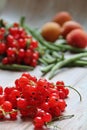 Green beans, green vegetables, beans scattered on a wooden background, redcurrant and fresh apricots, fruits and vegetables Royalty Free Stock Photo