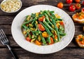 Green beans salad with Red, Yellow Tomatoes, bruschettas and flaked almond on white plate Royalty Free Stock Photo