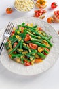 Green beans salad with Red, Yellow Tomatoes, bruschettas and flaked almond on white plate Royalty Free Stock Photo