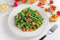 Green beans salad with Red, Yellow Tomatoes, bruschettas and flaked almond on white plate Royalty Free Stock Photo