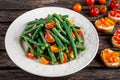 Green beans salad with Red, Yellow Tomatoes, bruschettas on white plate Royalty Free Stock Photo