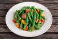 Green beans salad with Red, Yellow Tomatoes on white plate Royalty Free Stock Photo