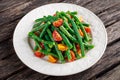 Green beans salad with Red, Yellow Tomatoes on white plate Royalty Free Stock Photo