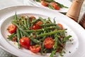 Green beans and tomato salad on white plate Royalty Free Stock Photo