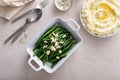 Green beans topped with almonds in a baking dish, traditional side dish for dinner or celebration Royalty Free Stock Photo