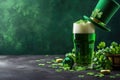 Green beer pint and leprechaun hat over dark green background, decorated with shamrock leaves Royalty Free Stock Photo