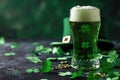 Green beer pint and leprechaun hat over dark green background, decorated with shamrock leaves Royalty Free Stock Photo