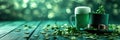 Green beer pint and leprechaun hat over dark green background, decorated with shamrock leaves Royalty Free Stock Photo