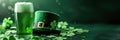 Green beer pint and leprechaun hat over dark green background, decorated with shamrock leaves Royalty Free Stock Photo