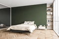 Green and beige bedroom, bed with linens bookshelf and mirror wardrobe Royalty Free Stock Photo