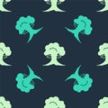 Green and beige Nuclear explosion icon isolated seamless pattern on blue background. Atomic bomb. Symbol of nuclear war Royalty Free Stock Photo