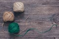 Green and beige tangles of thread on a wooden surface. Linen yarn. Royalty Free Stock Photo