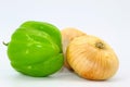 Green bell peppers and two onions placed on a light background Royalty Free Stock Photo