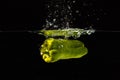 Green bellpepper falling into water with a splash Royalty Free Stock Photo